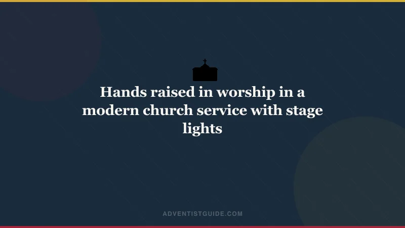 Hands raised in worship in a modern church service with stage lights