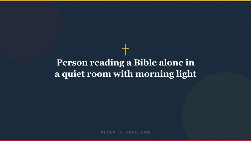 Person reading a Bible alone in a quiet room with morning light